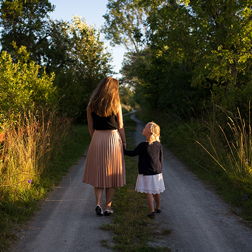 mother and daughter walking hand in hand