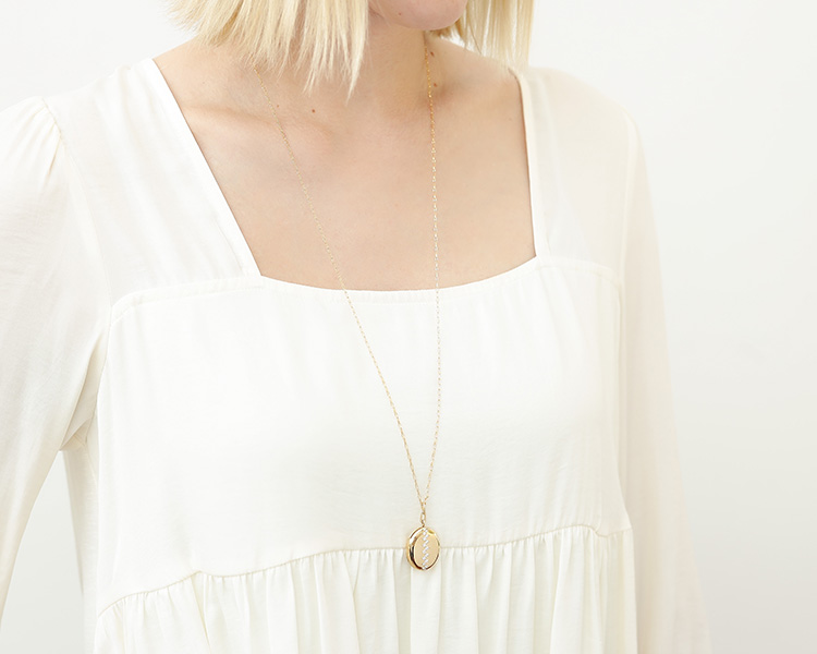 yellow gold locket necklace being worn