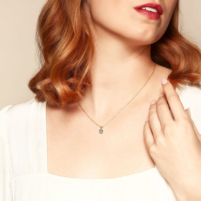 Topaz solitaire pendant on female model