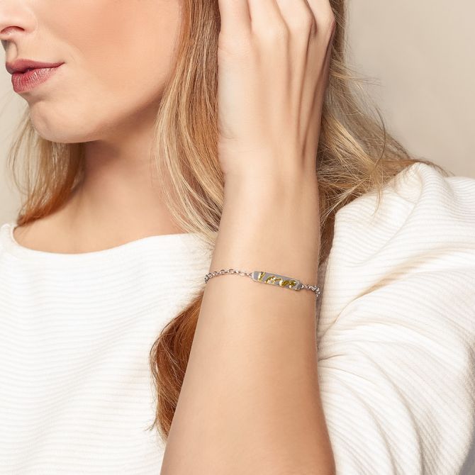 Woman wearing "Love" mixed metal bracelet for couples