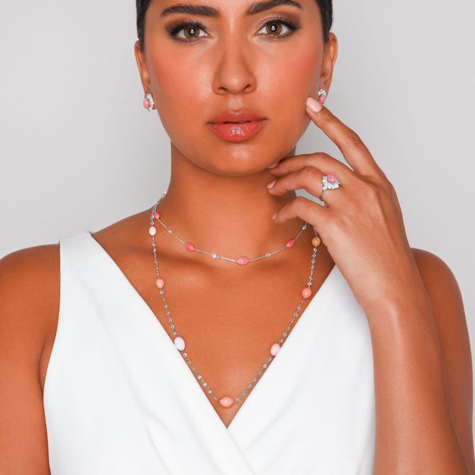 Woman wearing diamond and pearl station necklace