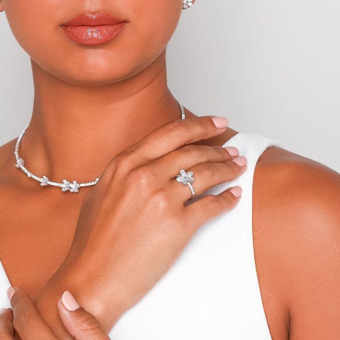 Woman wearing diamond floral ring with marquise and pear cuts