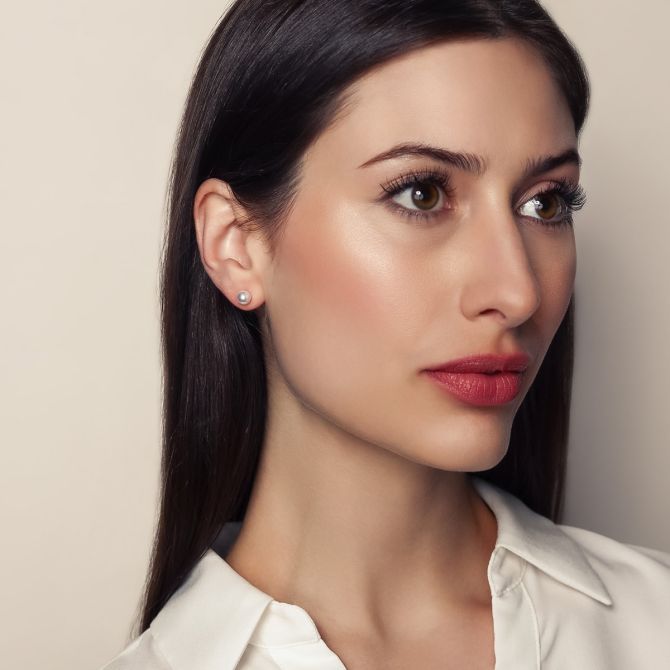 Woman wearing cultured pearl studs under $1,000