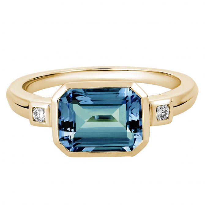 Emerald Cut Blue Topaz Ring with Diamond Side Stones in Yellow Gold