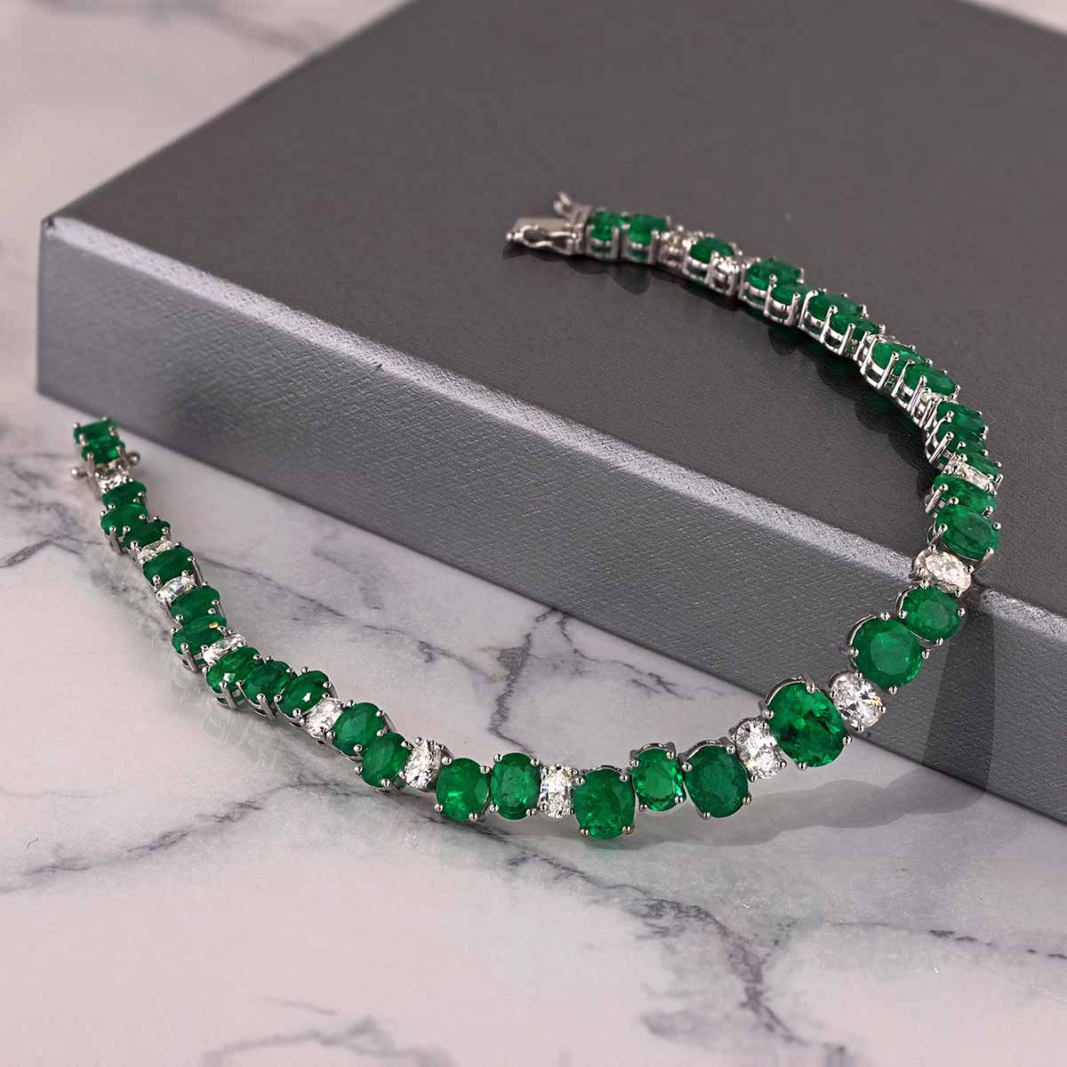 Oval Emerald, Oval & Round Diamond Staggered Tennis Bracelet in White Gold